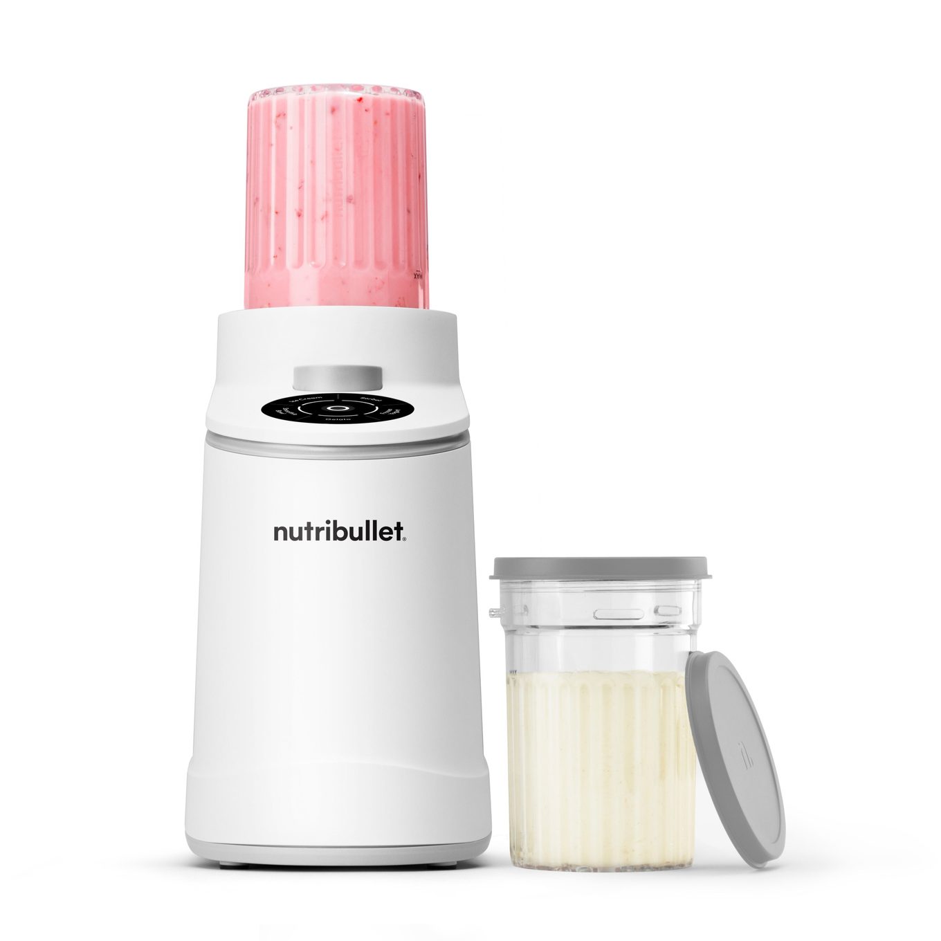 nutribullet Chill ice cream maker in white with a strawberry pint loaded upside down on the motor base and a second pint cup with lid alongside