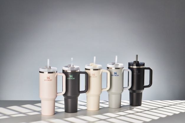 Five Stanley Quencher H2.0 FlowState 40-ounce tumblers in a row in launch colorways, each with handle and straw